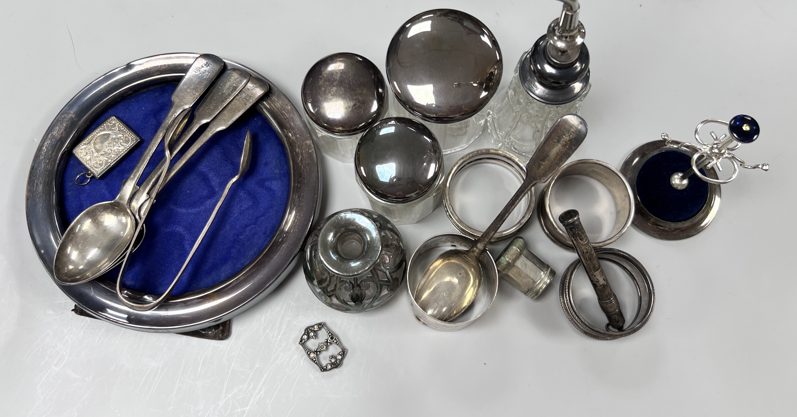 Sundry small silver including circular photograph frame, toilet jars, napkin ring ring tree etc.